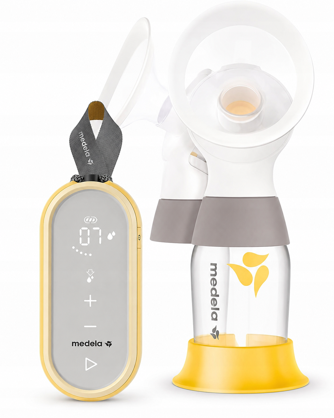 Laktator Medela Freestyle Flex obok lejka z butelką na żółtej podstawce.